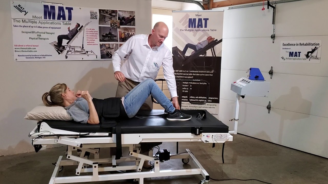 Demonstration: application of mechanical lumbar traction belts on the MAT table in Physical Therapy.