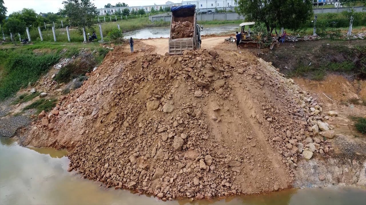 Wow! Amazing Landfill Project Use Dozer D20P Push Stone into Deep Water with 3T Dump Truck Unloading