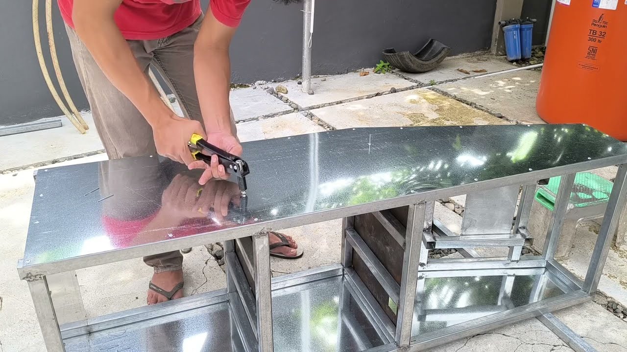 Proses pasang paku rivet pada plat dan besi hollow