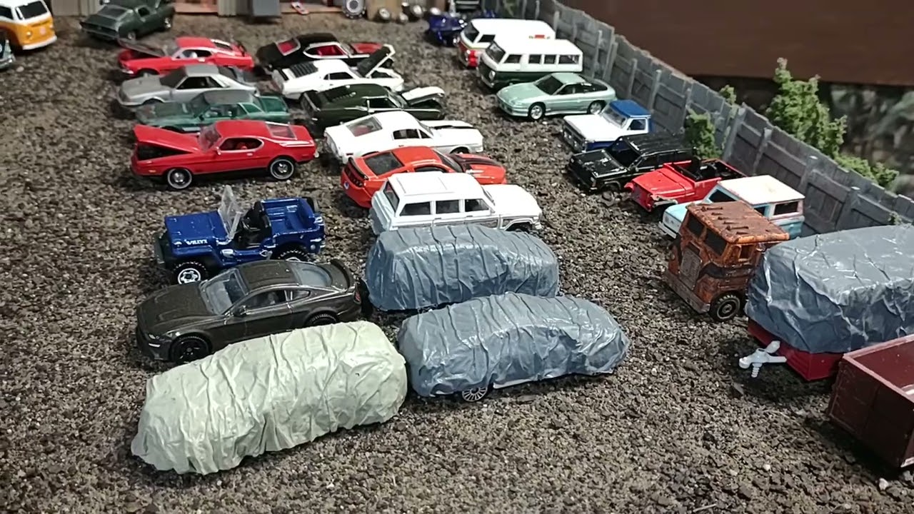 Model railroad update. It started out as a 1/87 junkyard and morphed into a 1/64 scale garage.