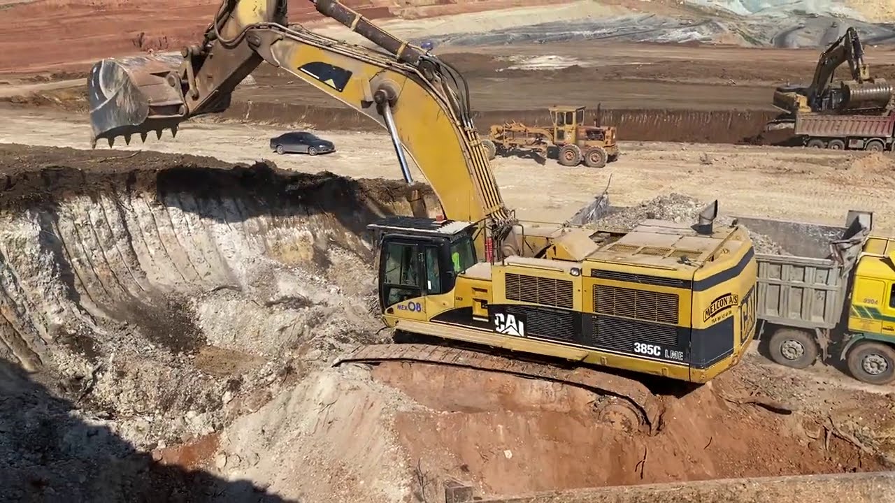 Caterpillar 385C Excavators Loading Trucks