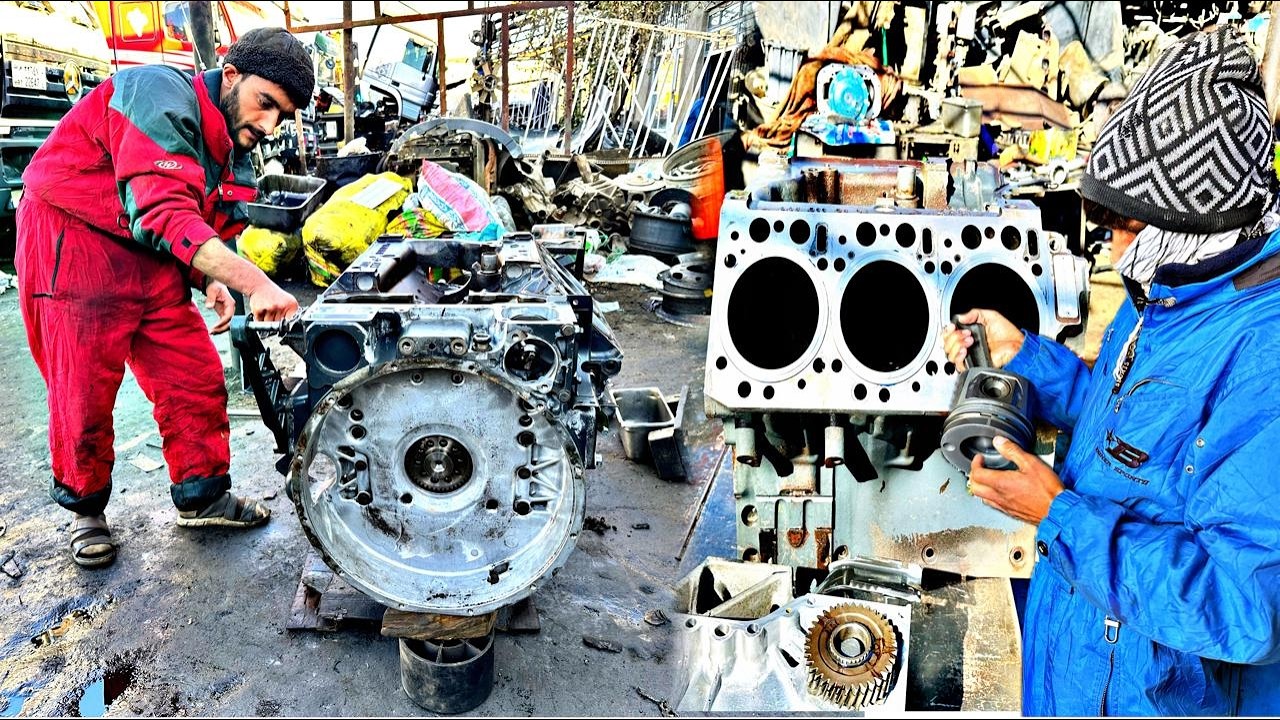 Engine Rebuild in Progress -  Skilled Mechanics Restoring a Heavy -  Duty Motor