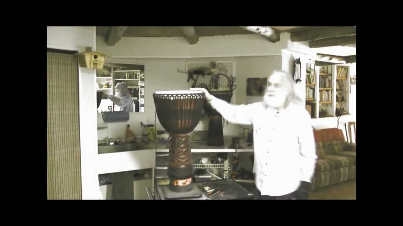 Putting a new head on a 3 ring Djembe.wmv