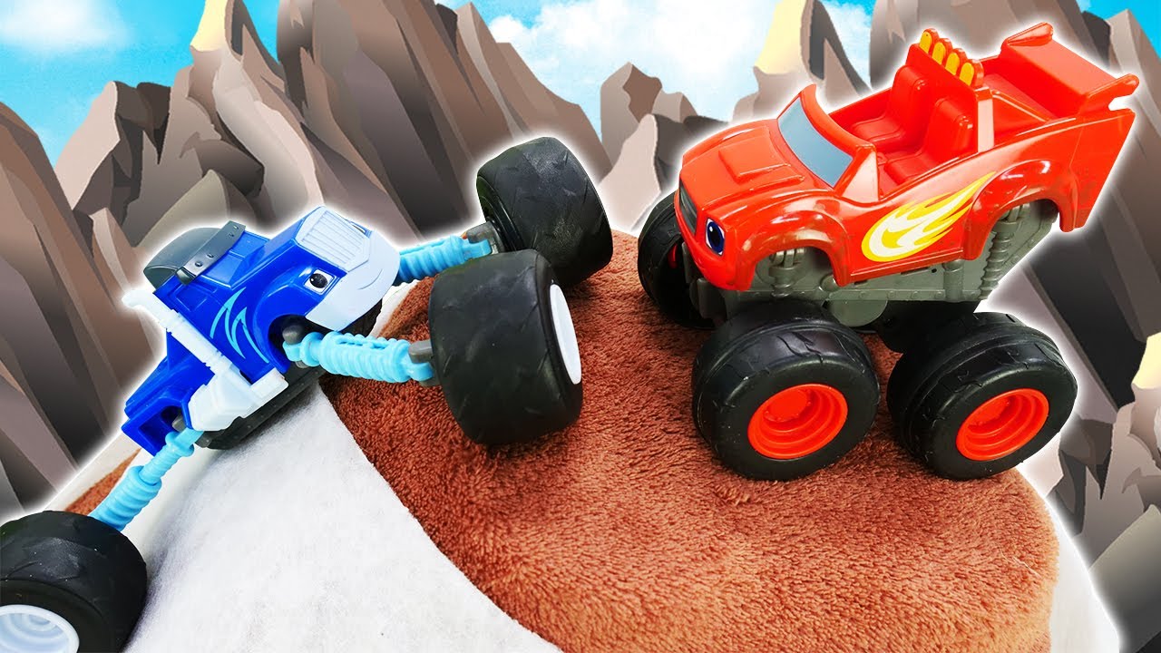 Blaze and Crusher the toy monster trucks go on a hike in the mountains for adventures.