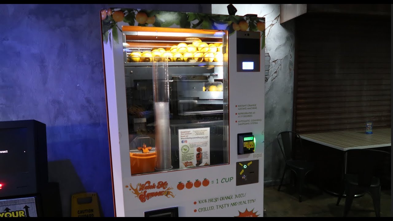 Using A Freshly Squeezed Orange Juice Vending Machine Wonderworks Orlando 2023