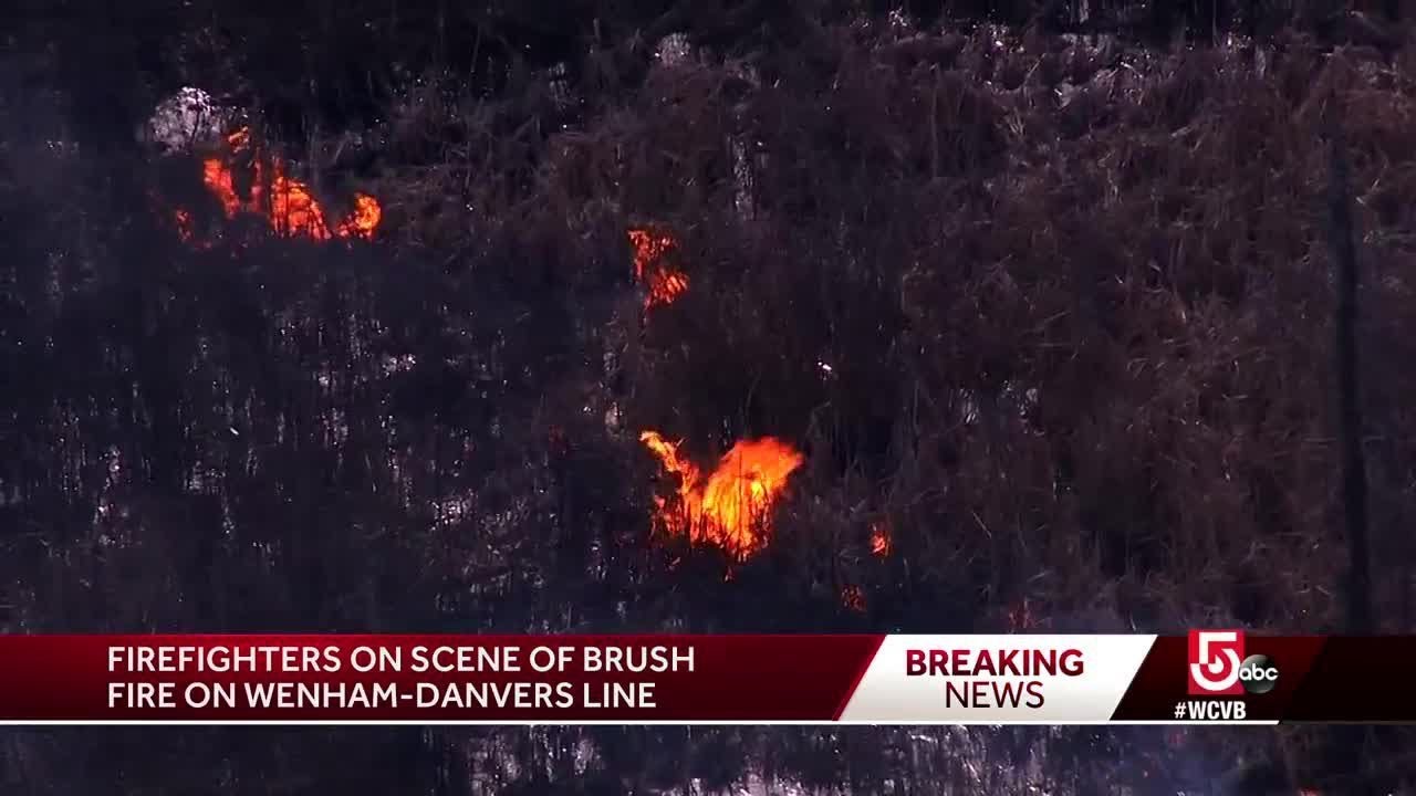 Firefighters work to contain brush fire on Wenham-Danvers line
