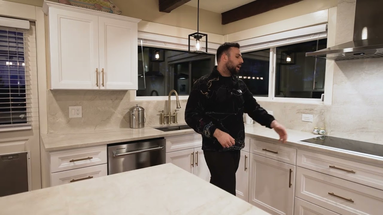Stunning kitchen remodel with a full layout transformation and elegant Taj Mahal quartzite