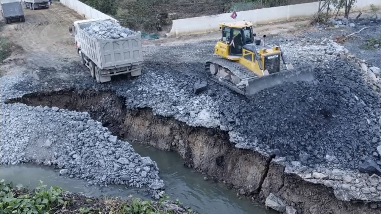 SHANTUI Dozer Filling Coverage The Sink Land With Dump Trucks