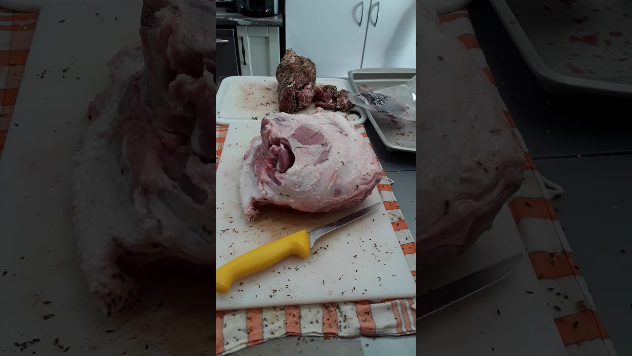 Skinning and de-boning porc picnic shoulder roast.