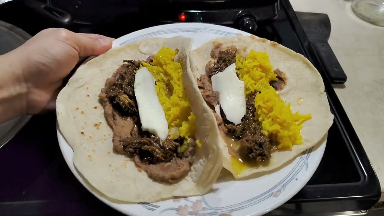 Rice beans brisket with onions and cheese tacos . And homemade tortillas 