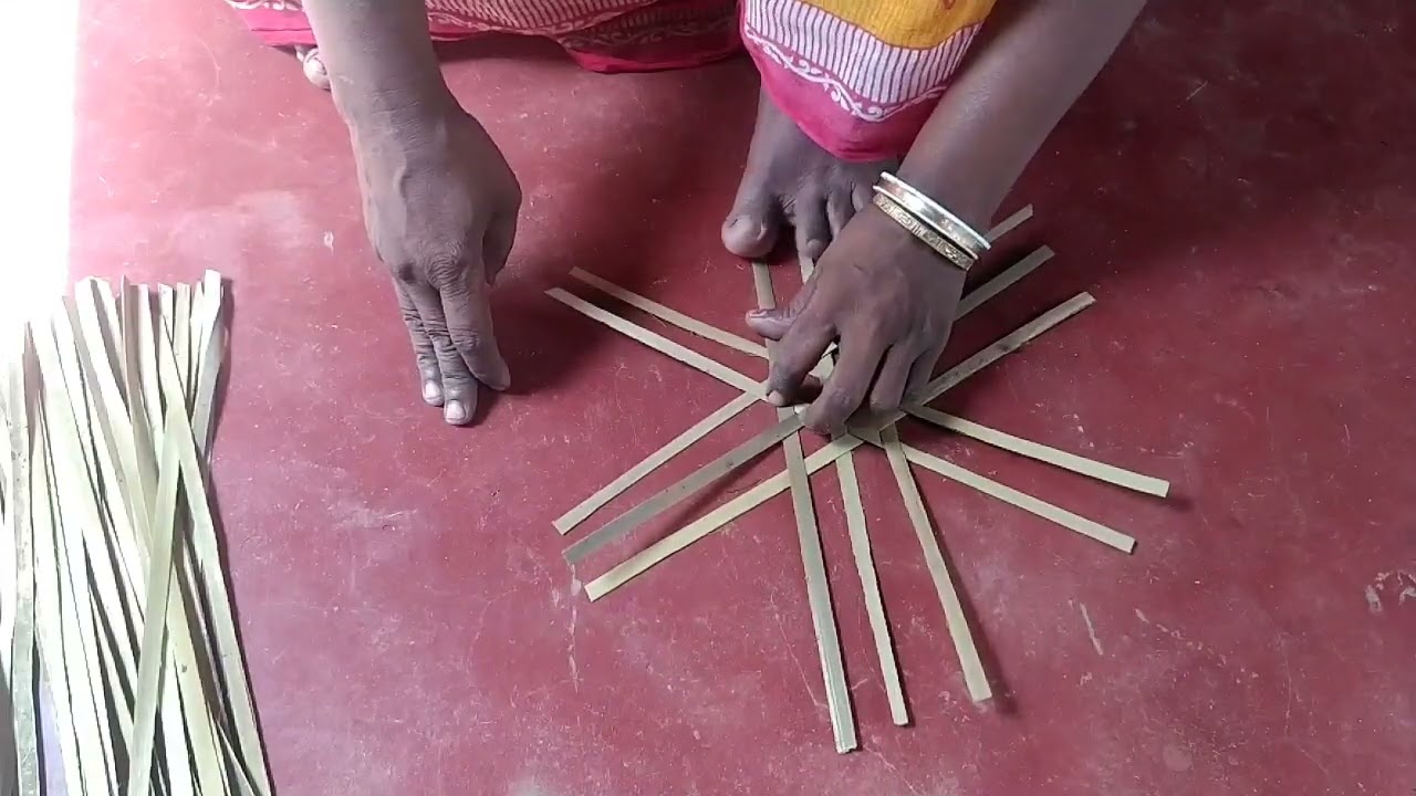 তাল পাতা দিয়ে পাখা তৈরী ।