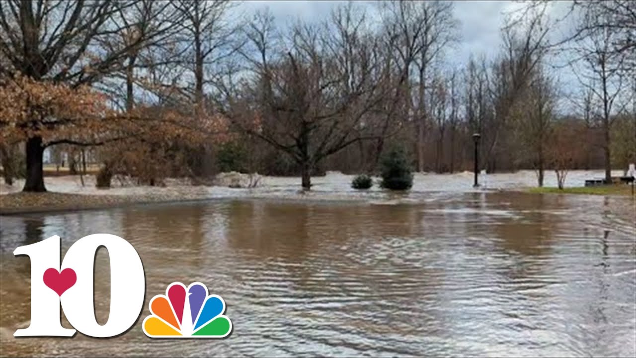 Little Pigeon River swells in Pigeon Forge behind Christmas Place, flooding parking lot