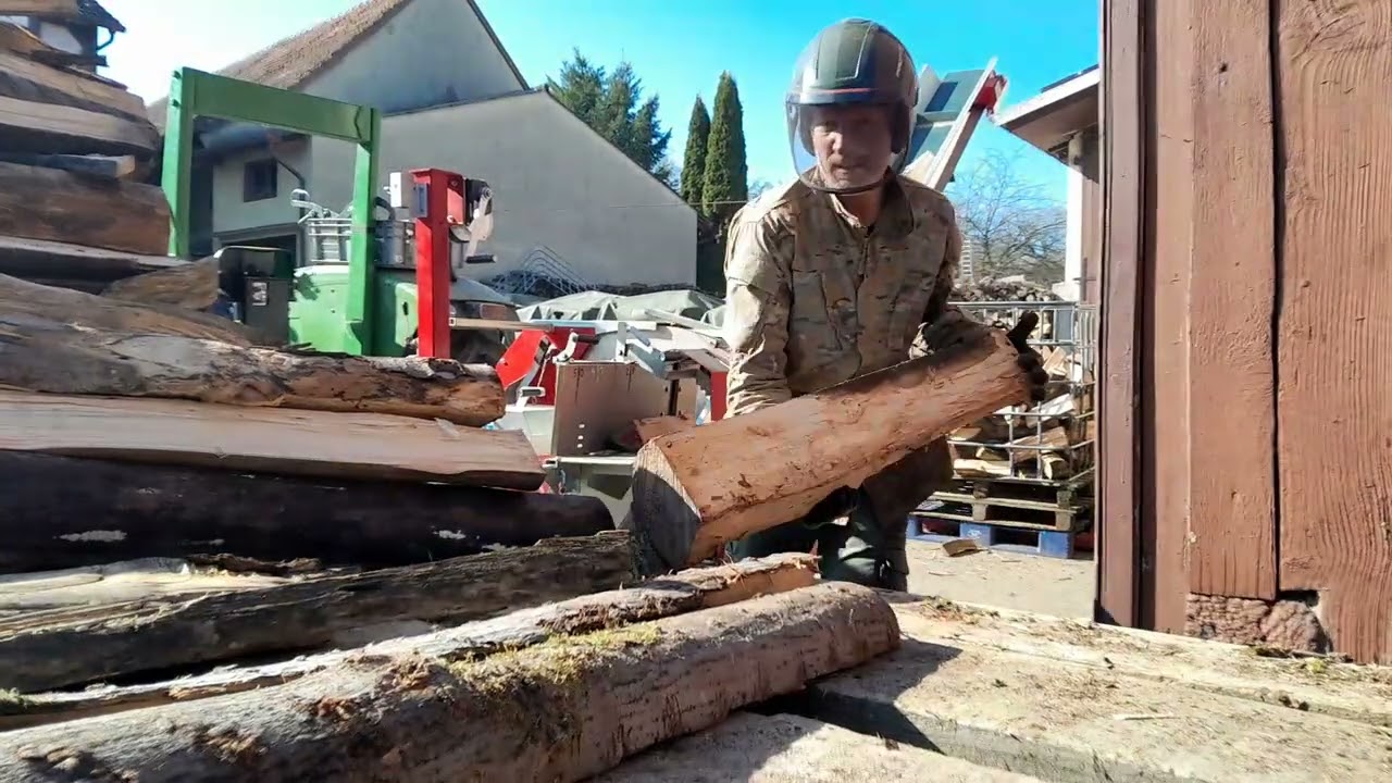 Cutting firewood to final length. 