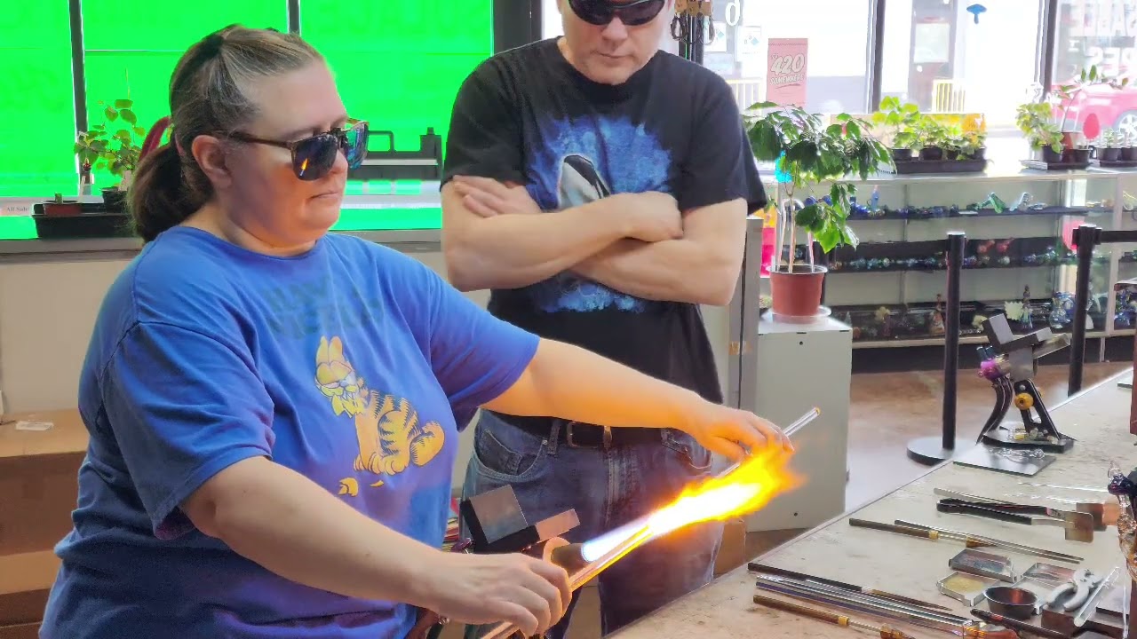 Lori Picou at #Glassgods_Spokane giving a beginner glassblowing lesson. Give us a call to book one.