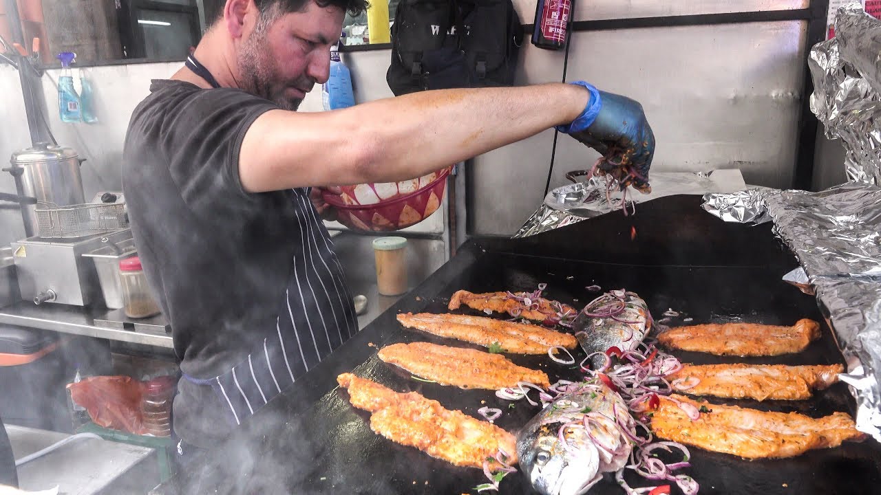 Cooking Lot of Fish on Grill. Mediterranean Street Food, London