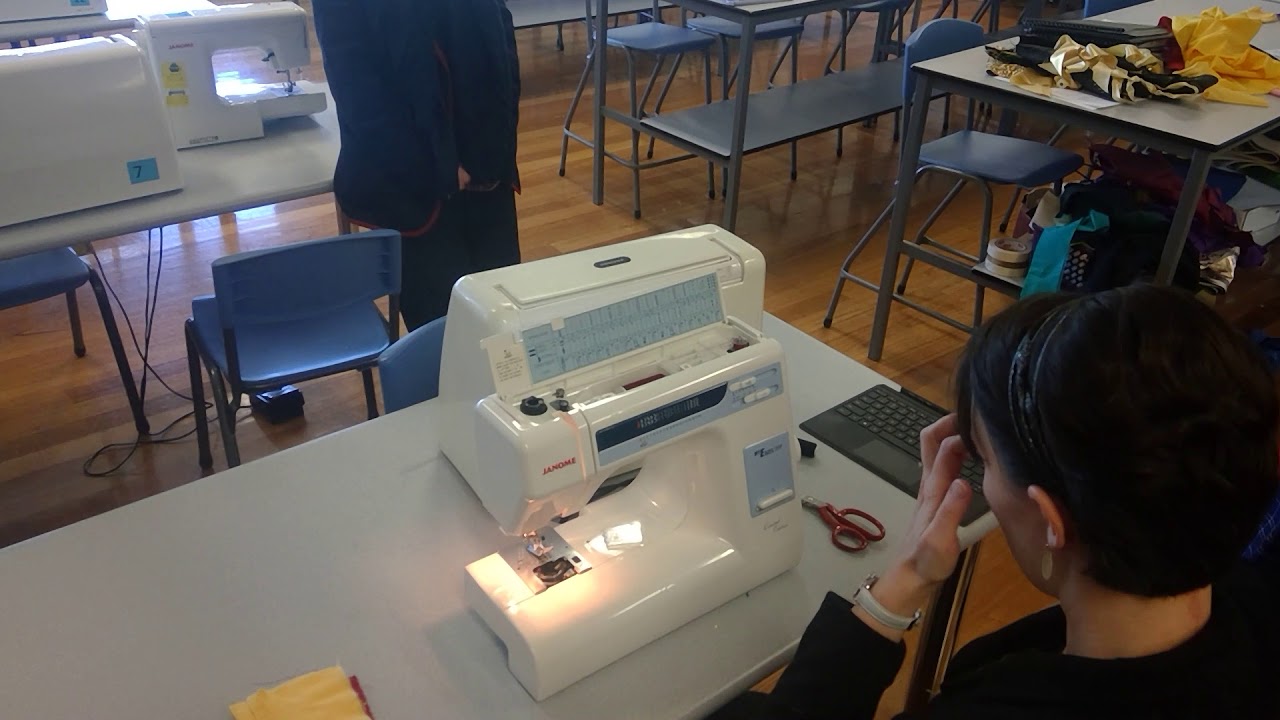 Threading a domestic sewing machine