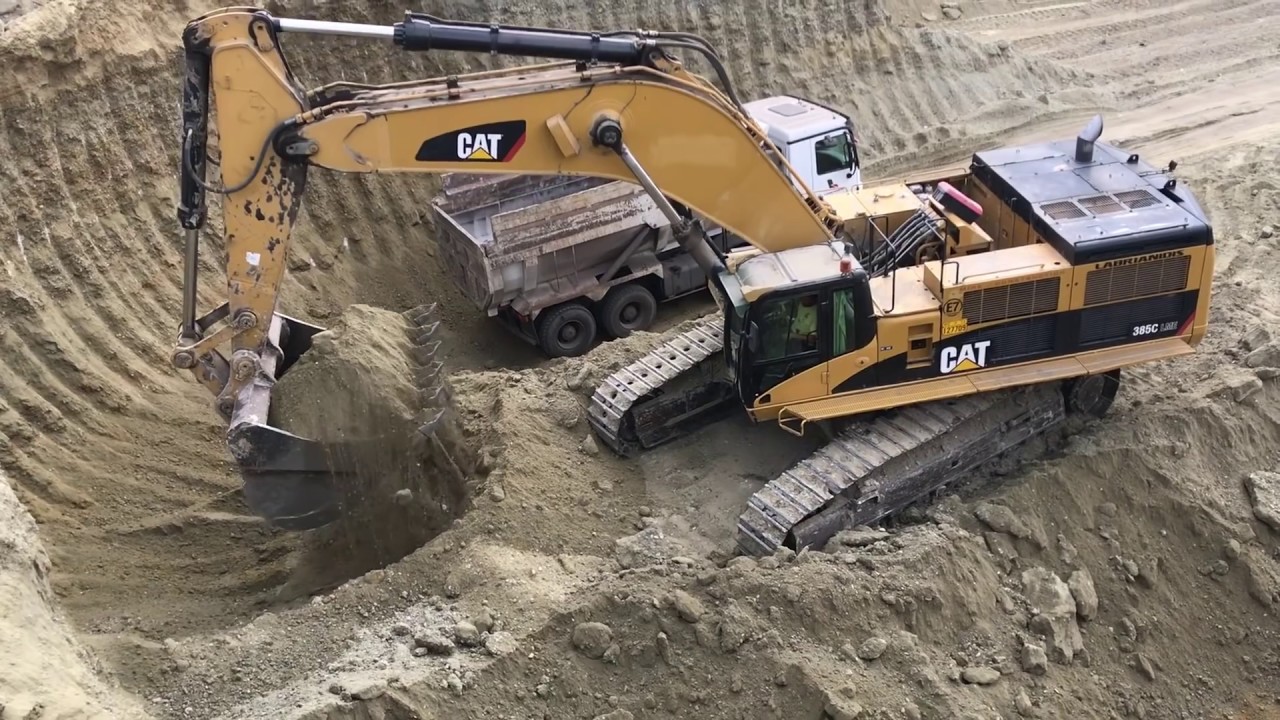 Caterpillar 385C Excavator Loading Trucks