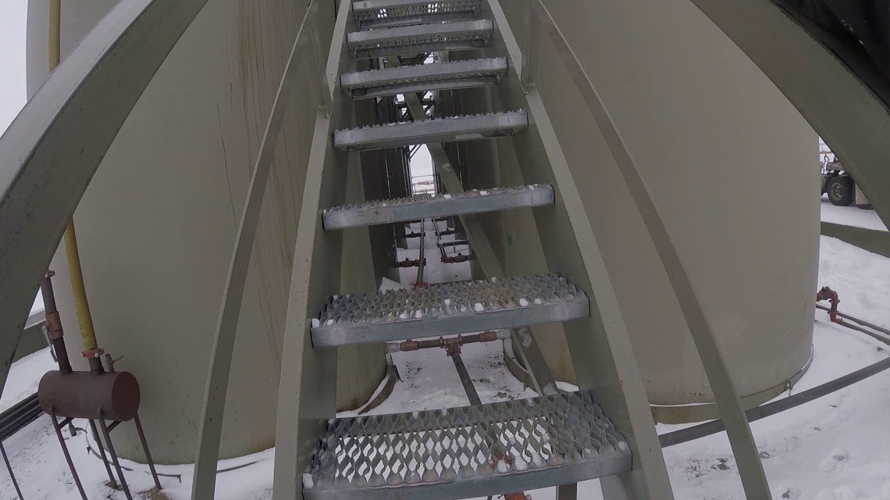 Oilfield Work/Strapping production tank to tell levels