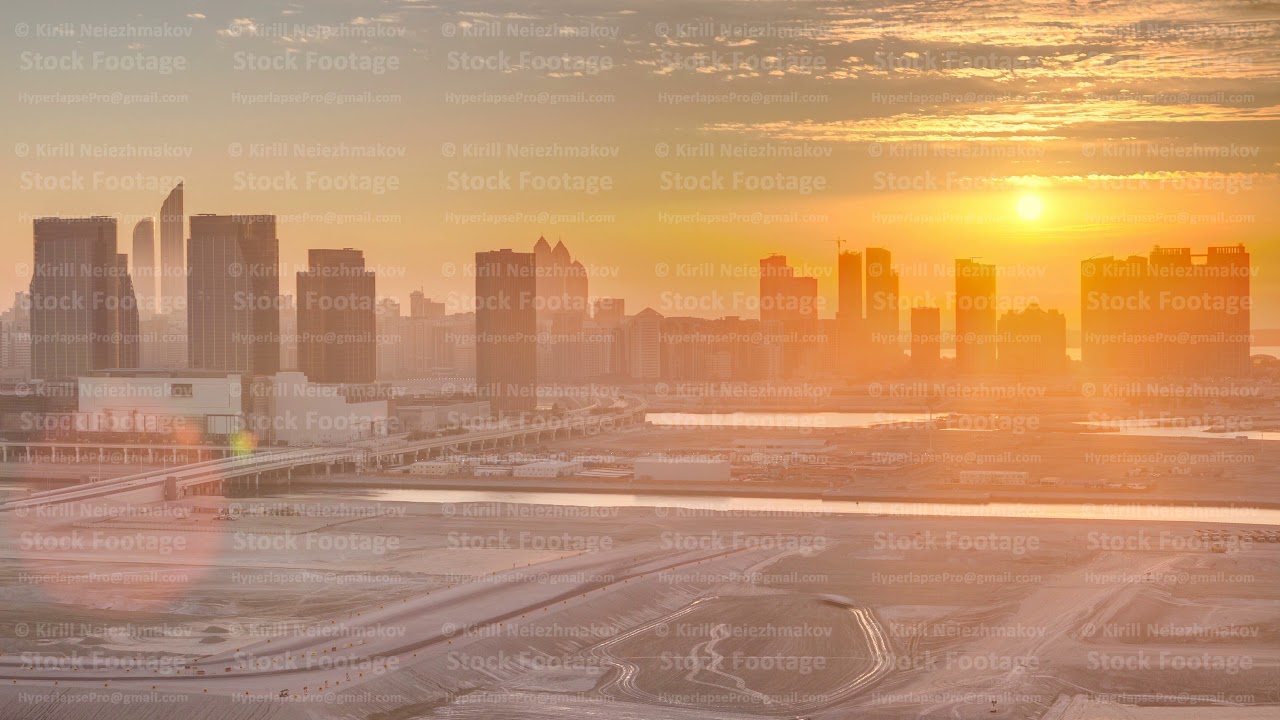 Buildings on Al Reem island in Abu Dhabi at sunset timelapse from above.