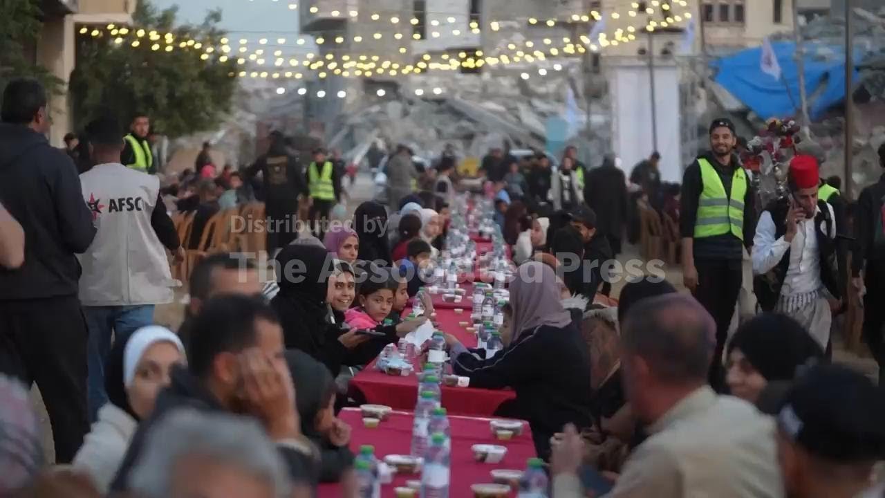 Hundreds gather in Khan Younis for a communal 'iftar' organised by a charity