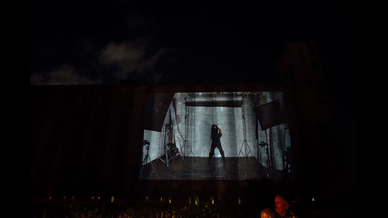 Nicole Chochrek dancing on a grain silo to the music of Charlie Martin