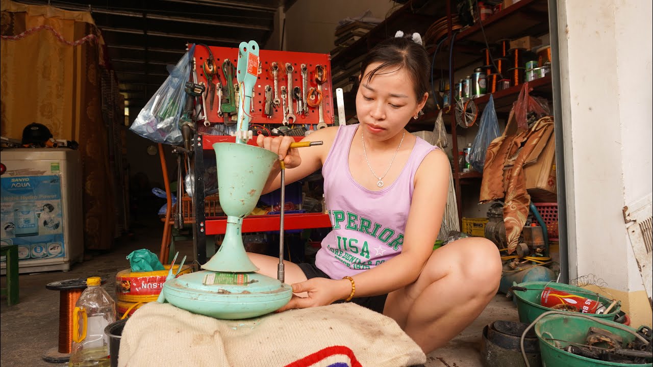 Household mishaps during the rainy season: Girl rolls up ceiling fan as water leaks into the motor.