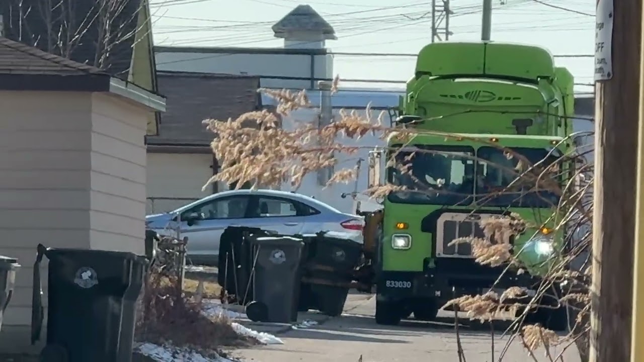 GFL Environmental’s CNG Peterbuilt 520 Labrie Expert packing heavy alley recycling.