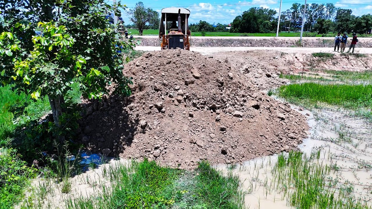 Amazing skills bulldozer operator push soil and filling up land with dump trucks greatly 