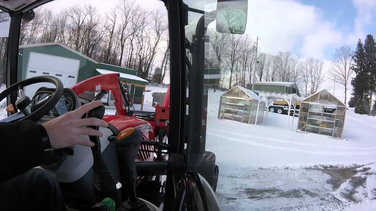 Mccormick tractor  plowing snow