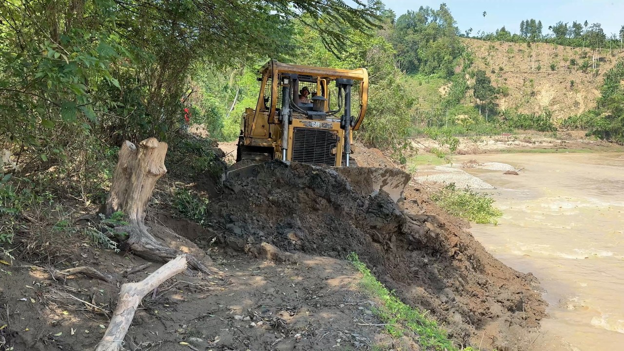 Due to Flooding, D6R XL Bulldozer Repairs Roads by the River
