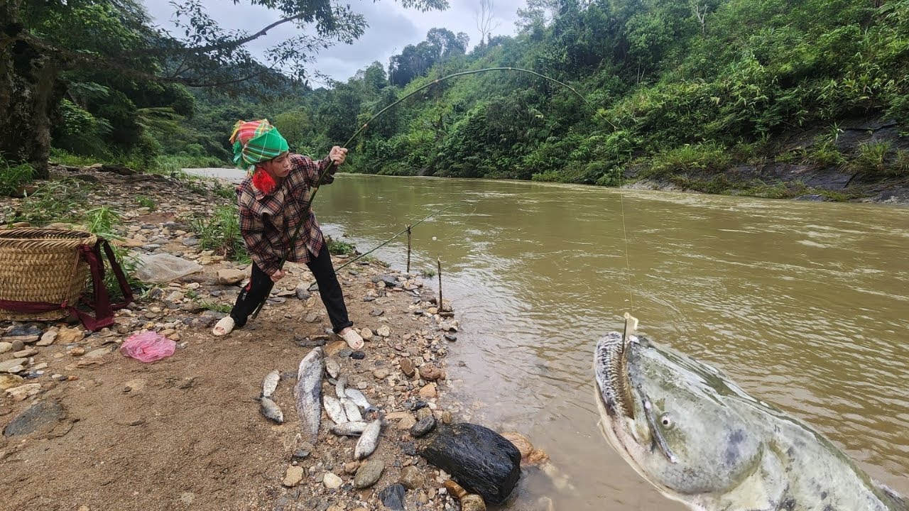 The girl unexpectedly caught a giant fish in the stream on a stormy day.