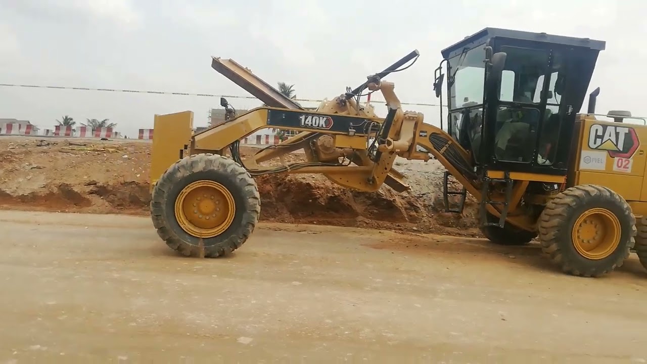 Caterpillar Grader setting its blade to  cut edge slopes
