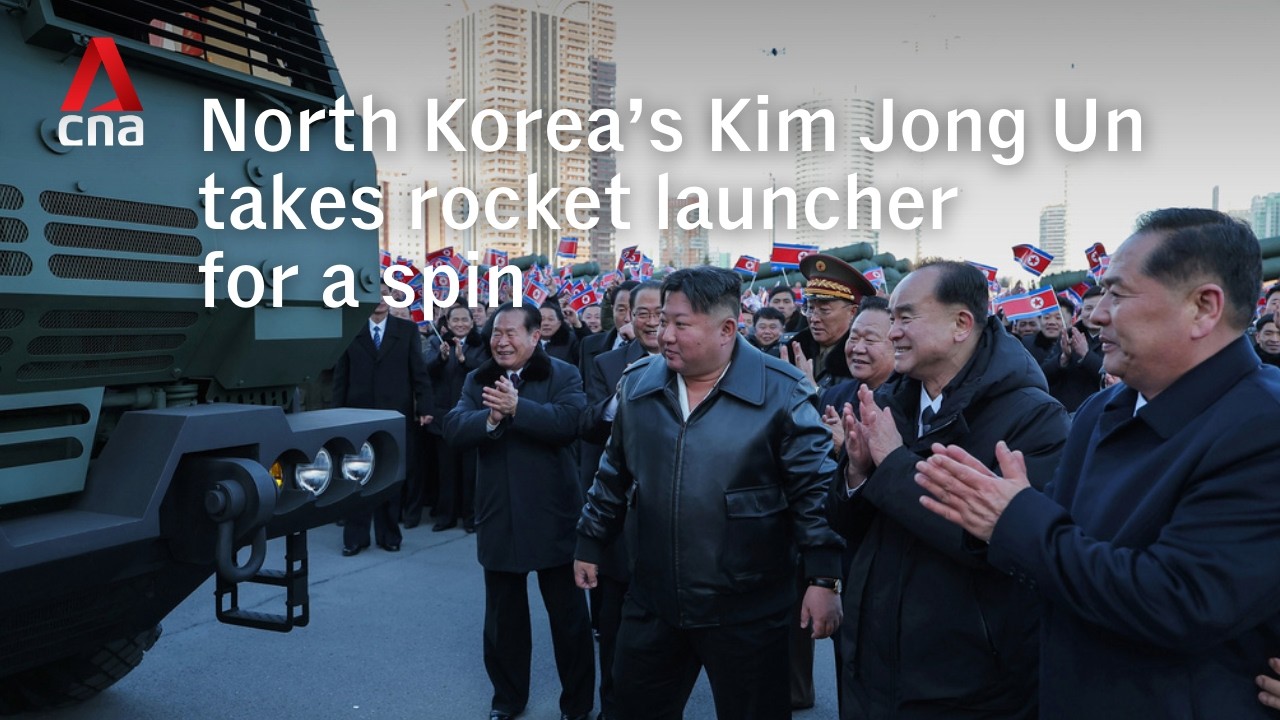 North Korean leader Kim Jong Un drives rocket launcher vehicle