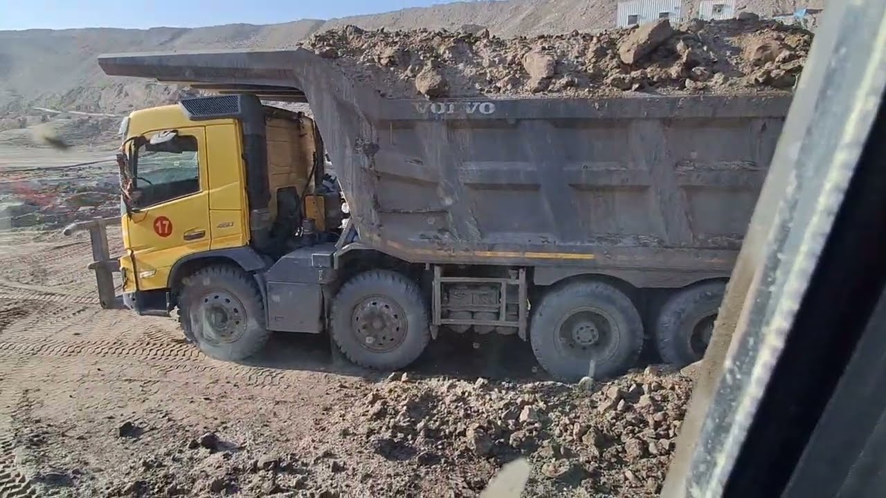 excavator loading trucks cab view