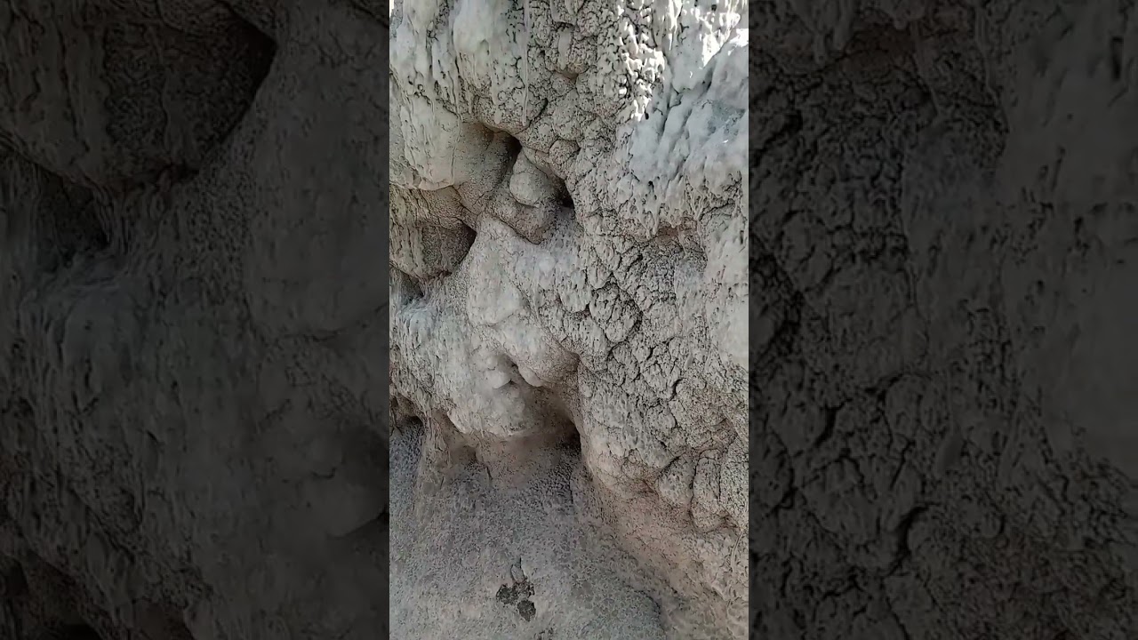 THIS VOLCANIC ASH STUCK TO THE SAND CLIFF WALLS