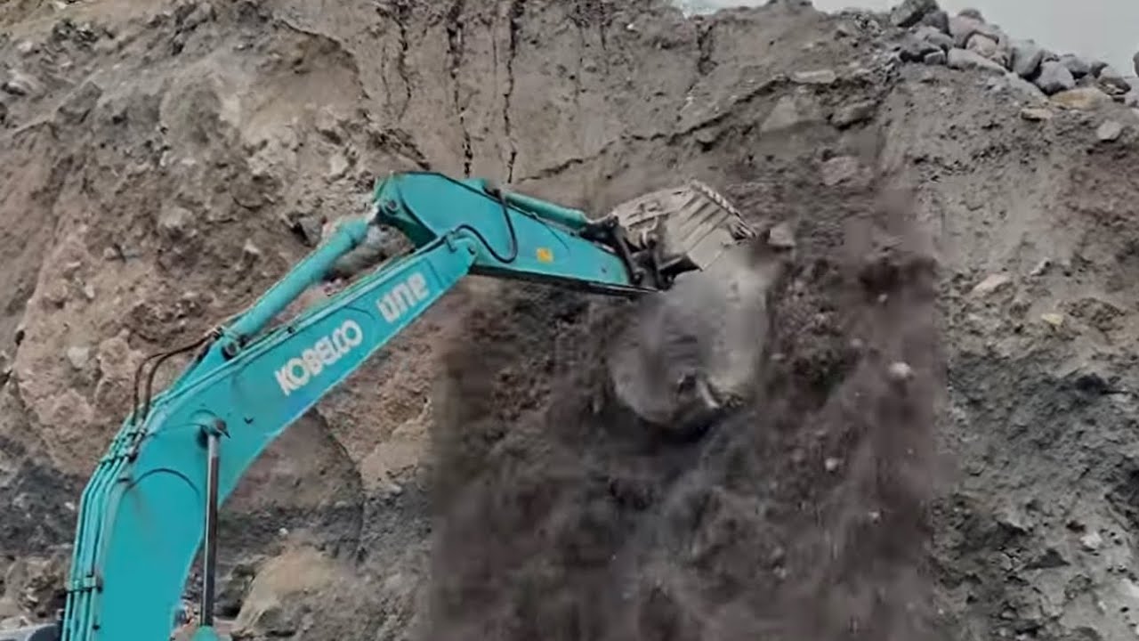 Sand mining||excavator working in sand mining tearing down cliffs