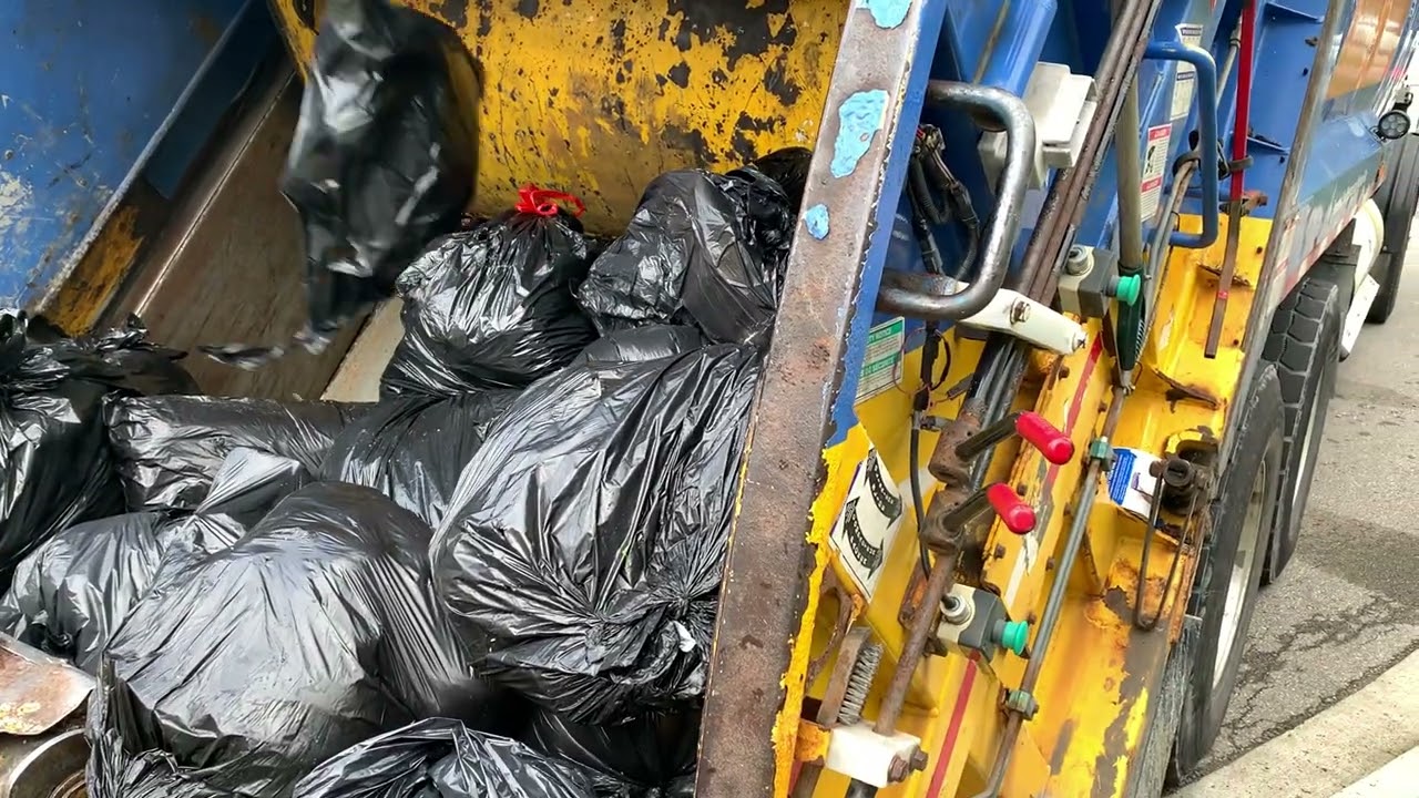 Mississauga garbage truck crushing black bags