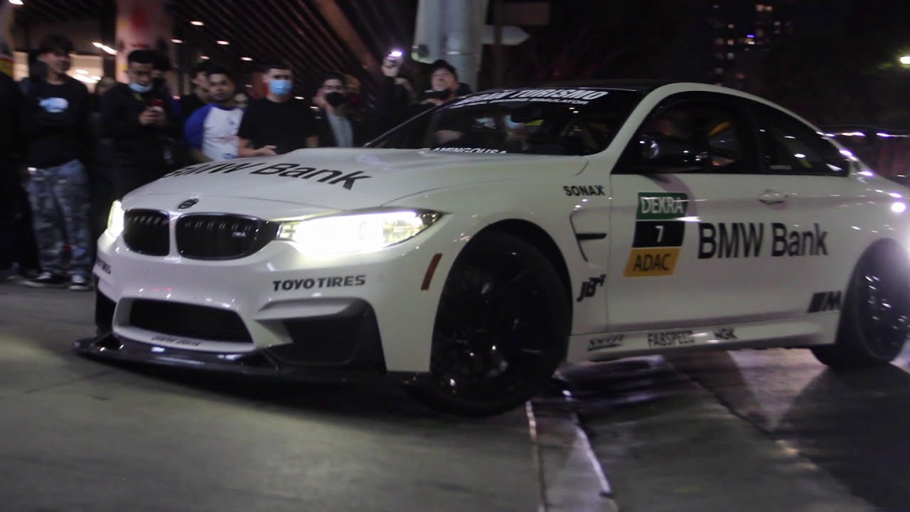 Modified Cars Entering a Steep Driveway