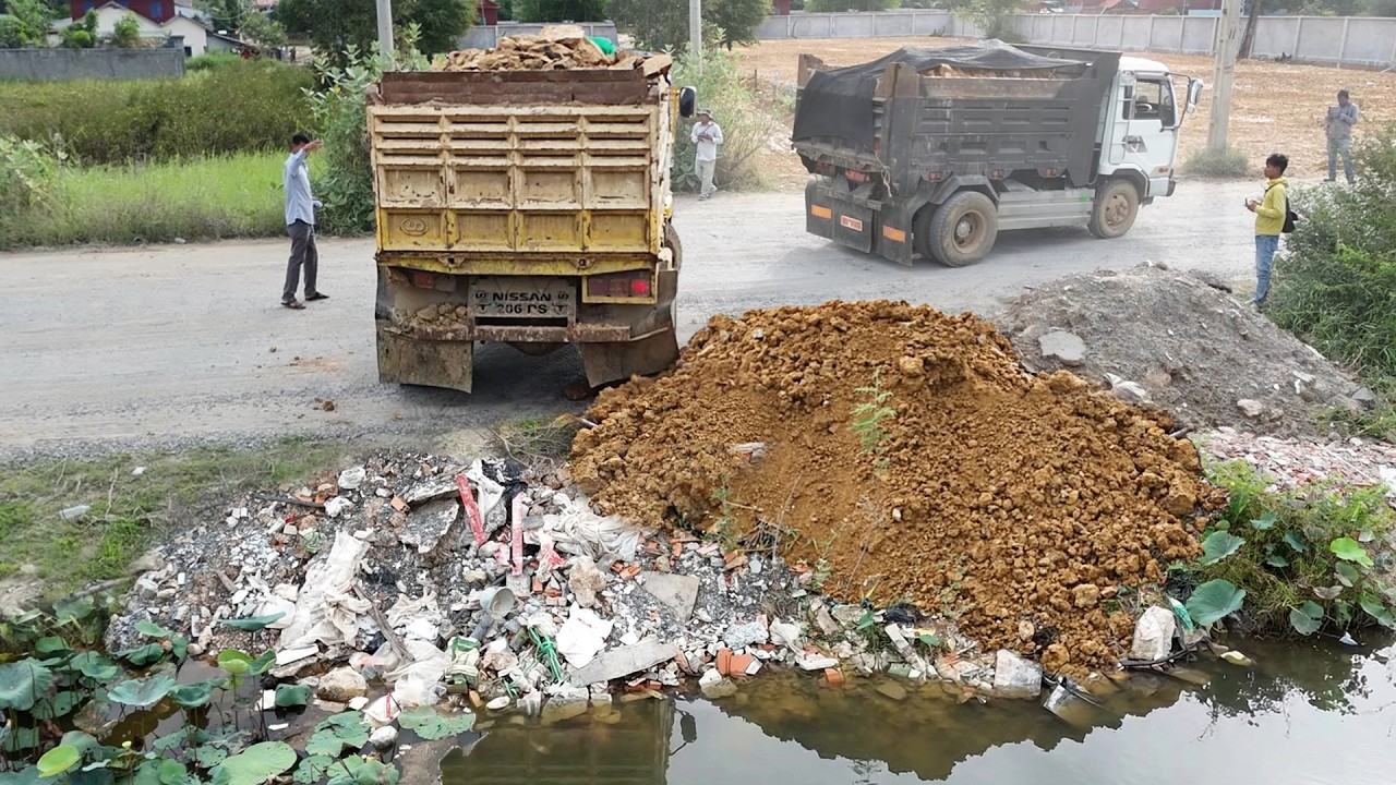 Perform Nice Process, Talented Operator filling Soil to water using trucks 5ton & Mini Dozer