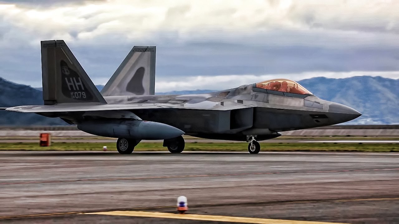 F-22 Raptors Punch Holes In The Clouds Over Japan