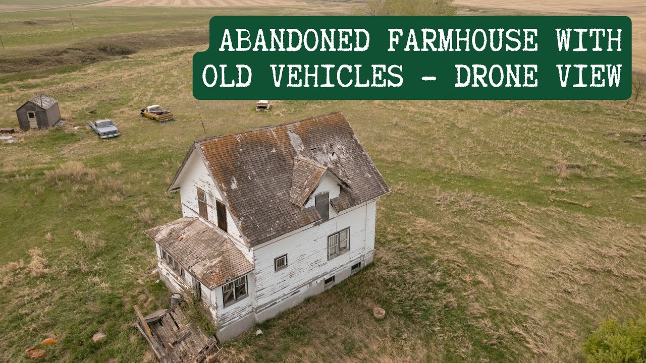 Drone Footage: Abandoned Farmyard with White Farmhouse & Vintage Trucks