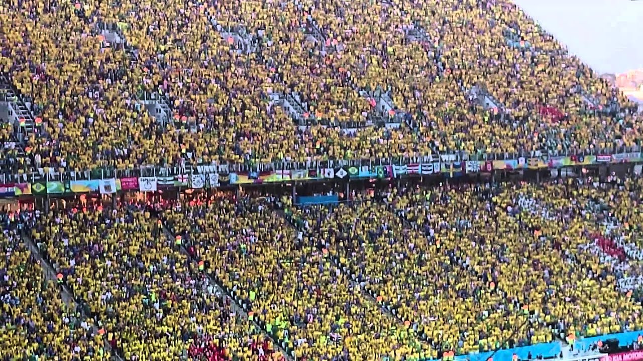 Brazilian supporters sing the national anthem