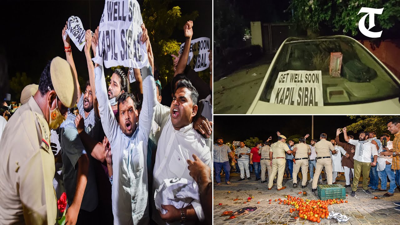 Congress workers protest outside Kapil Sibal's residence holding placards with Get well soon message