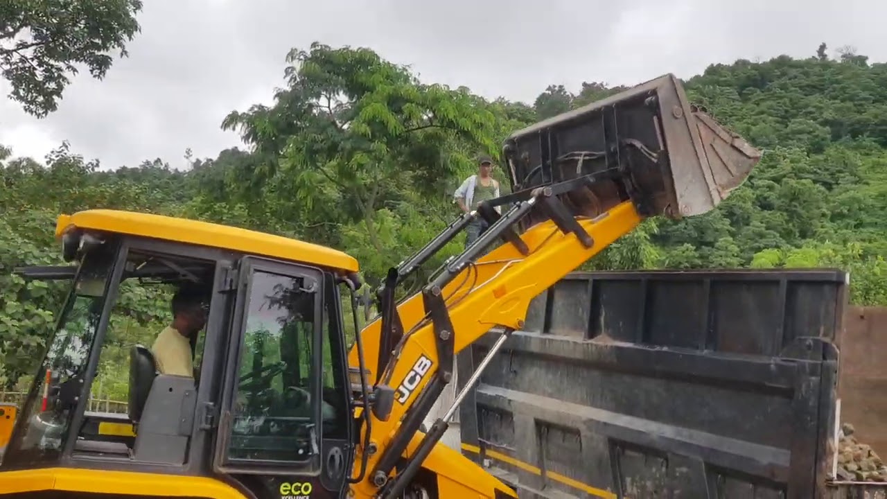 Jcb 3dx super loading gravel in a dump truck (tipper)