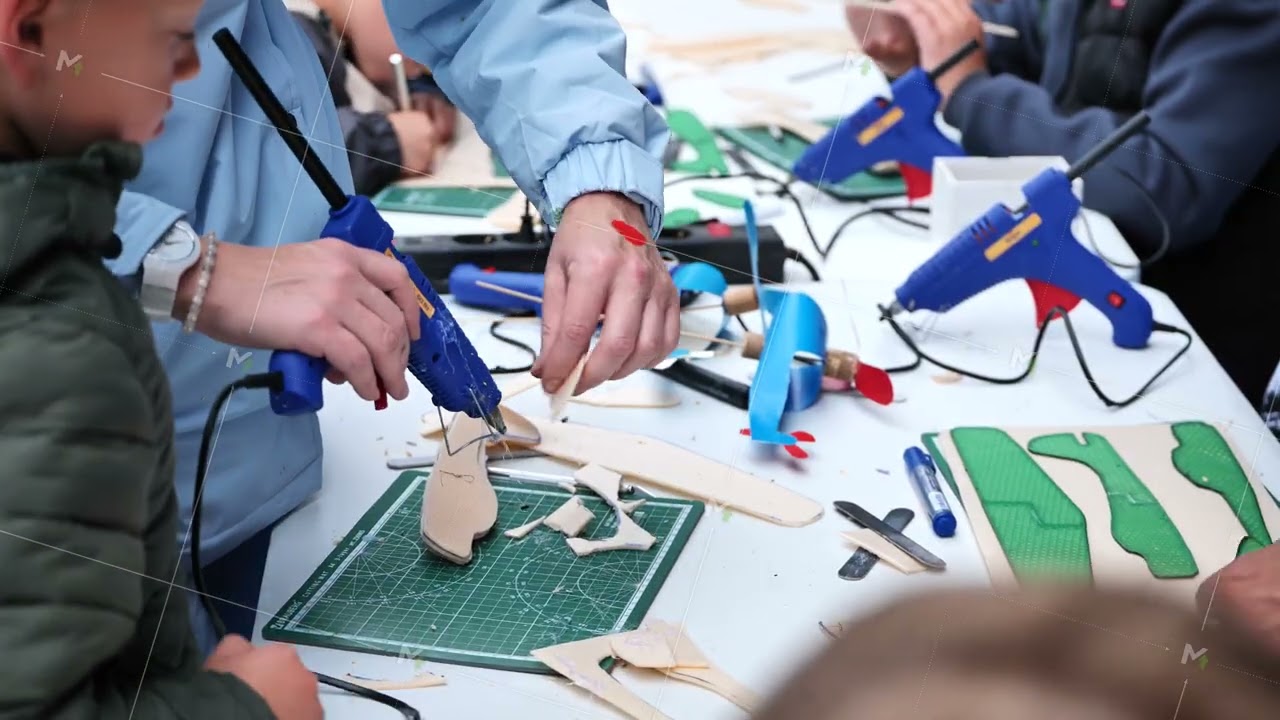 Moscow, Russia - August 17, 2025: Hands-on STEM learning workshop building model airplanes with glue