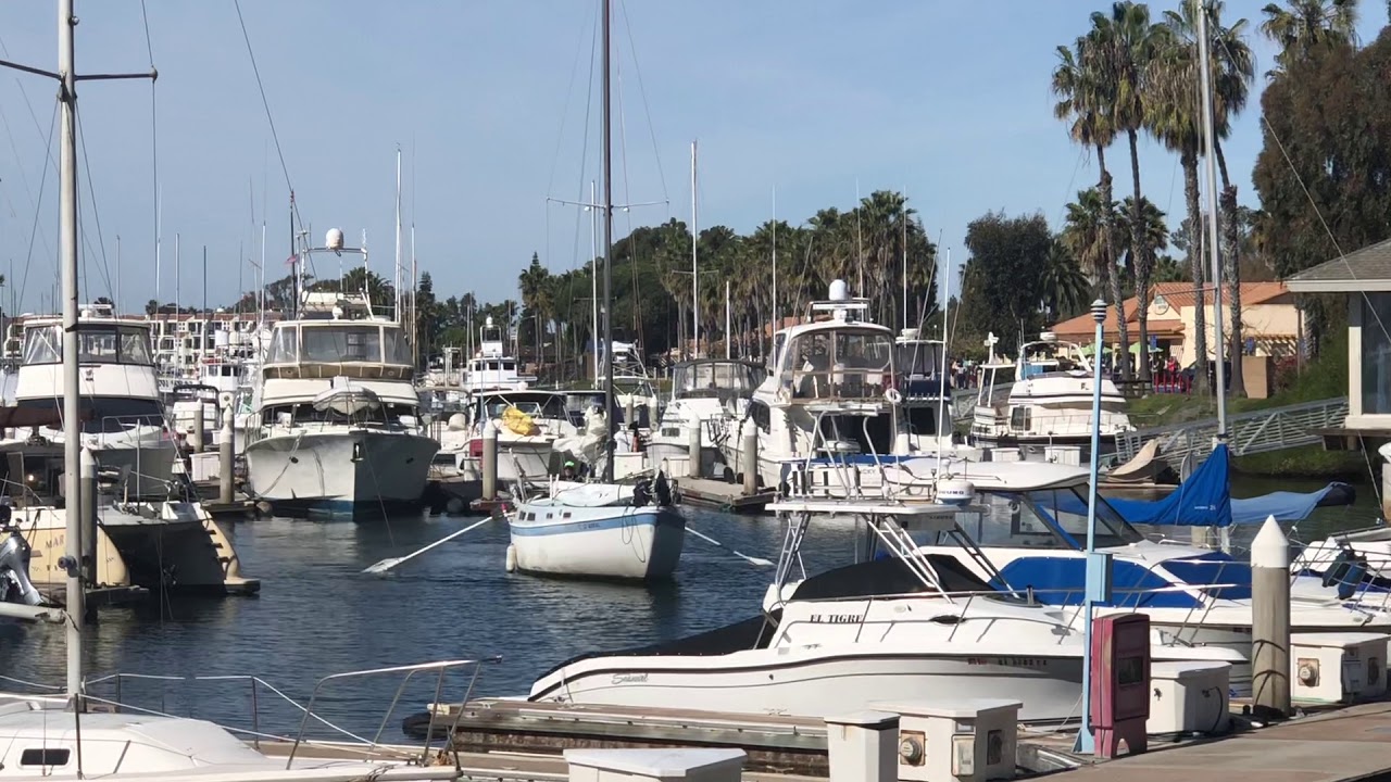 Sailboat with long oars coming into dock