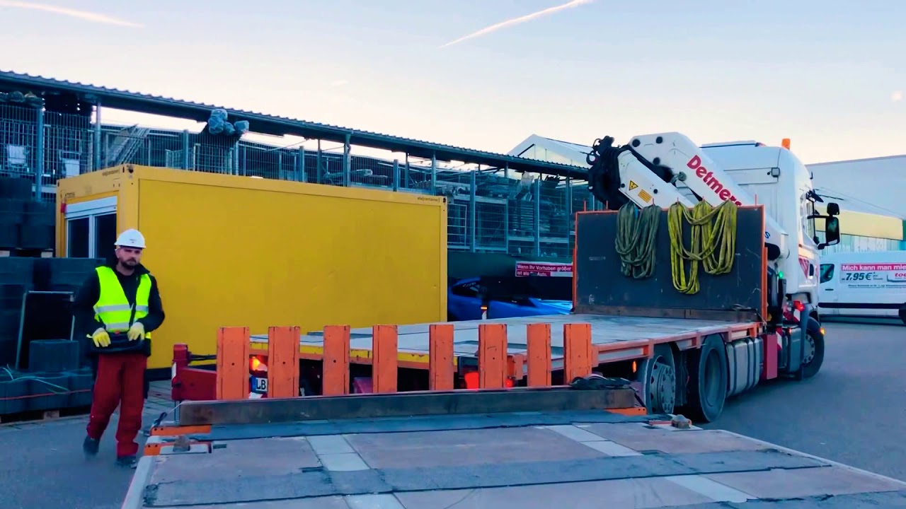 CraneTrucker Raumcontainer wird auf Scania LKW mit HMF Ladekran beladen