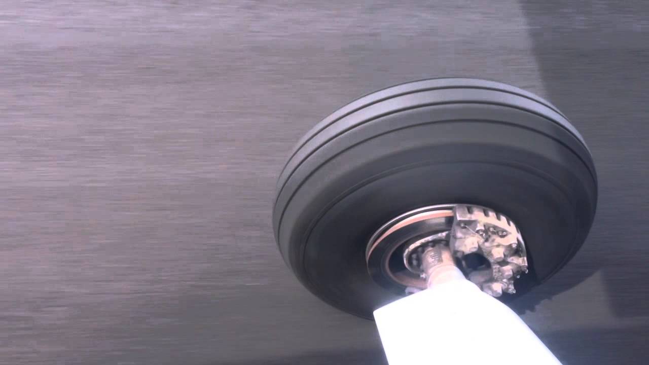 Landing gear tire smoke hitting the airfield strip
