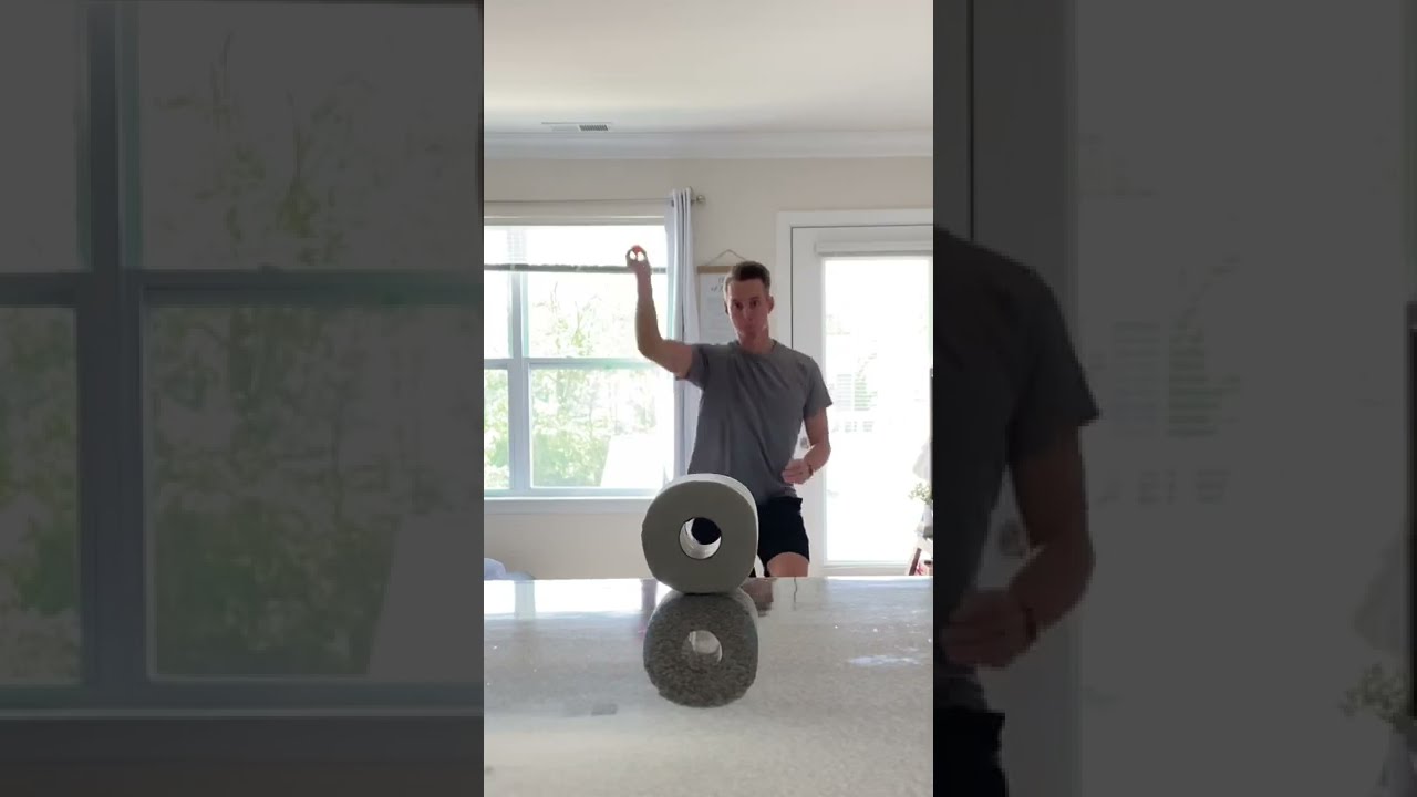 Guy Throws Ping Pong Ball Through Hole in Toilet Paper Roll - 1336568