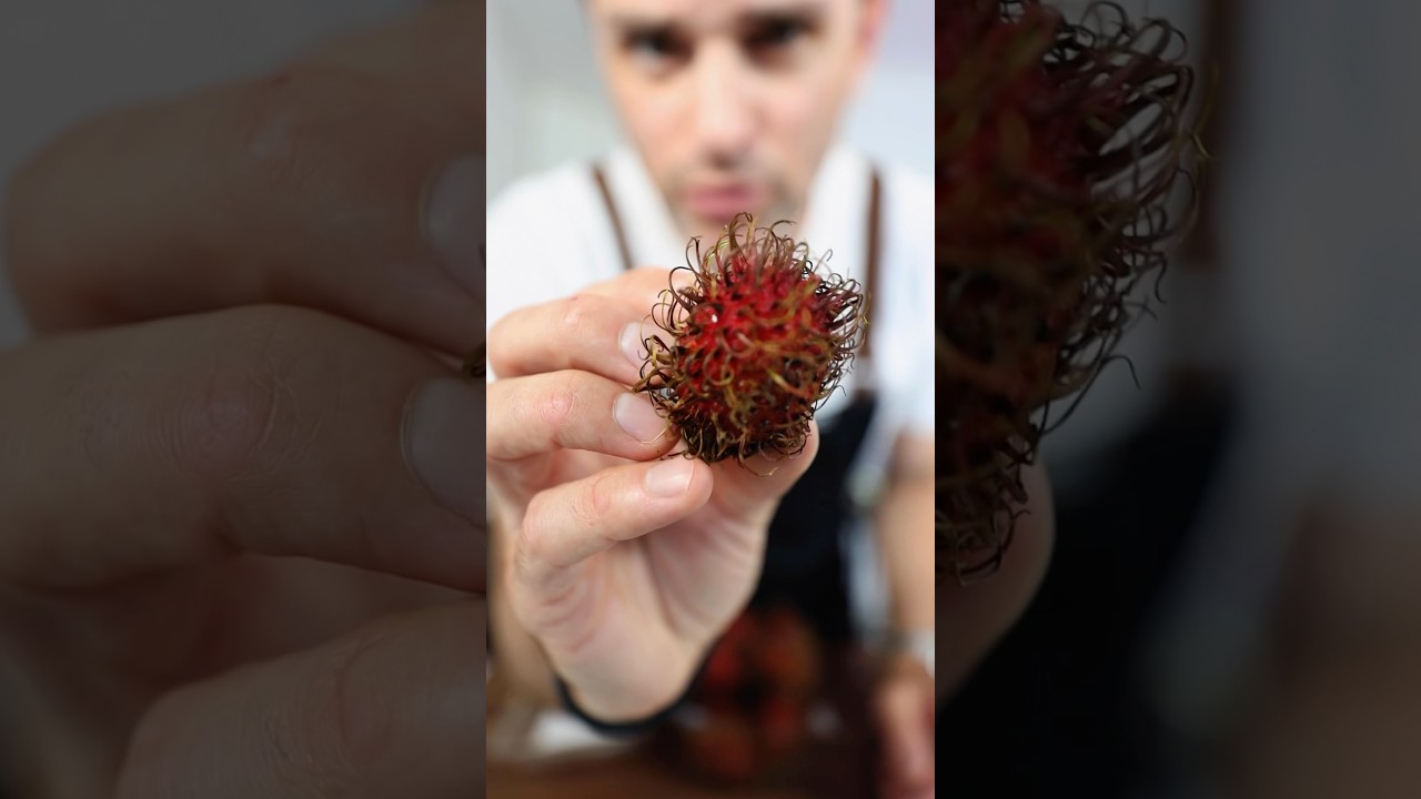 Trying this food. No idea what it is. (Rambutan)